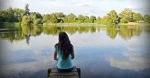 Girl Praying by a Lake